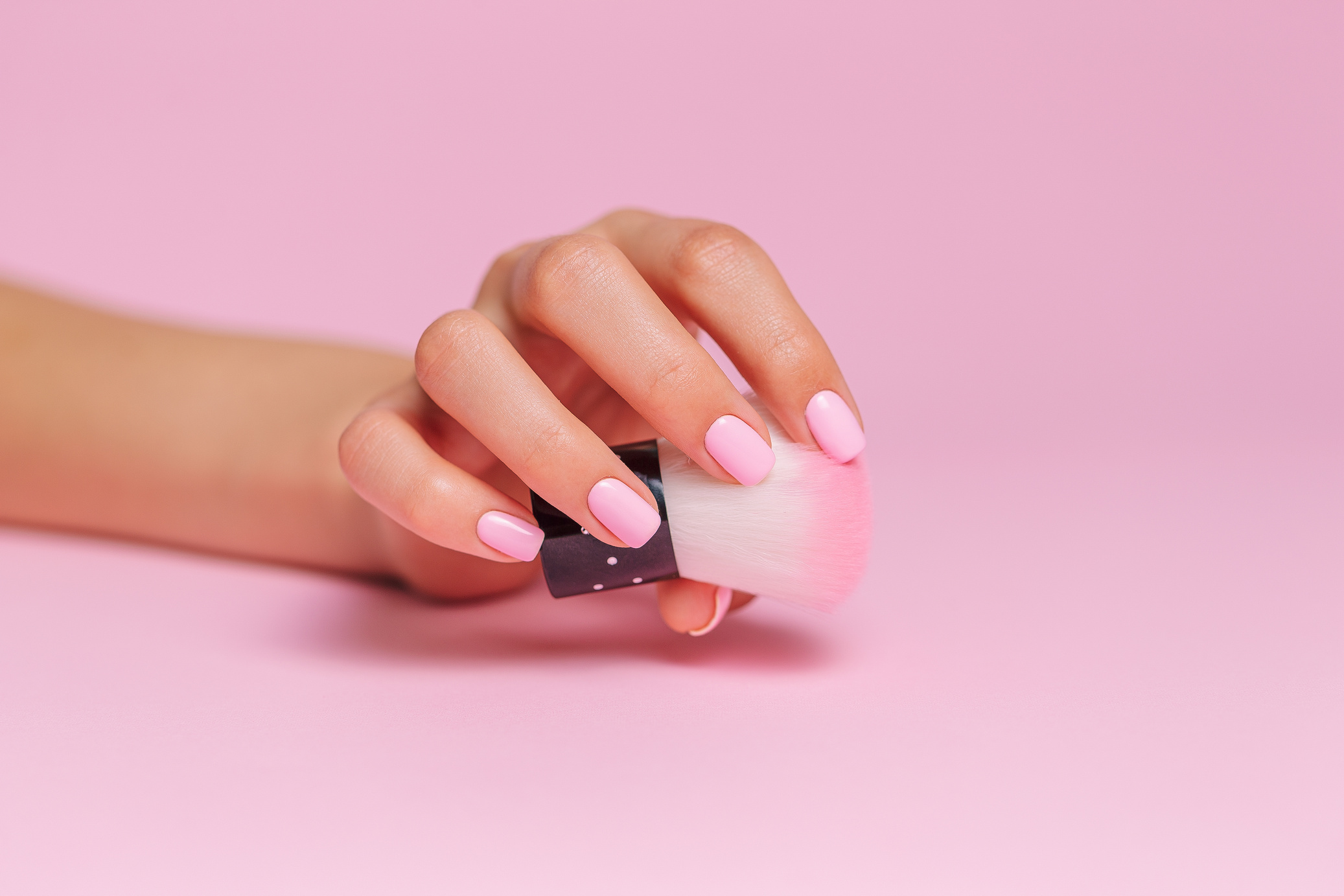 Hand Holding a Makeup Brush